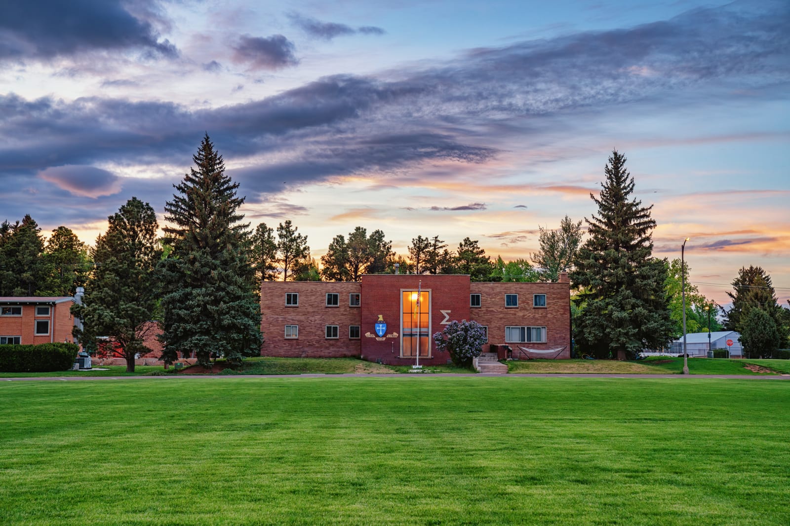 The Sigma Chi Fraternity at 1629 Fraternity Row at the University of Wyoming campus in Laramie, Wyoming, with Fraternity Row Park in the foreground.